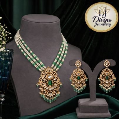 Graceful 92.5 silver gold-plated layered necklace set with pearl & emerald beads, kundan pendant, and matching statement earrings. Perfect for festive